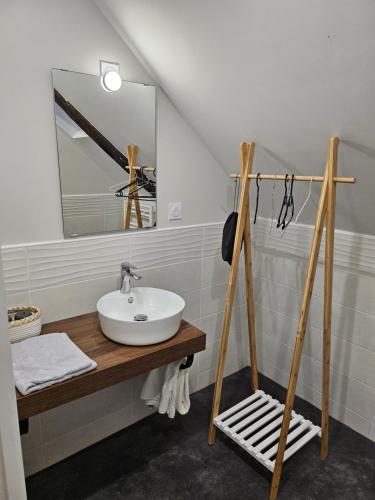 a bathroom with a sink and a mirror at Moulin de Kerstrat in Brennilis