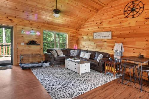 a living room with a couch and a table at Enchanted Forest Cabin And Teepee! Lights & Laser Show! Private Hot Tub! Unique Stay! in Sevierville