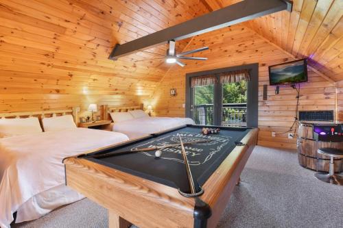 a room with a pool table in a cabin at Ryes and Shine Bootlegger's Cabin! Hot Tub* Pool* Arcade* Billiards *EV * Pet Friendly in Sevierville