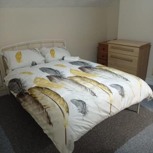 a bed with a white comforter with feathers on it at En-suite Double Room 277GC2 Salford Manchester in Manchester