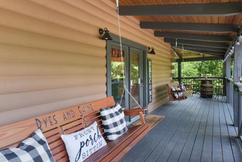 a wooden bench on the porch of a house at Ryes and Shine Bootlegger's Cabin! Hot Tub* Pool* Arcade* Billiards *EV * Pet Friendly in Sevierville