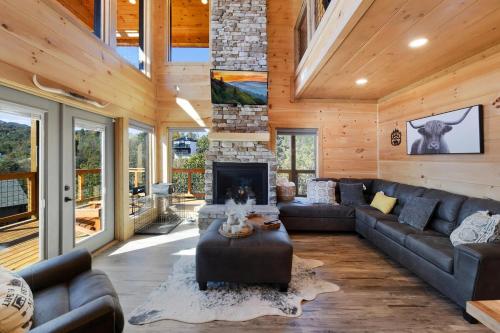 a living room with a couch and a fireplace at Big Bear Shack - Handicap Accessible & Dog Friendly in Gatlinburg