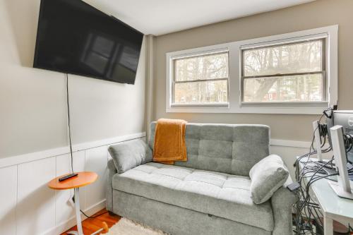 a living room with a couch and a flat screen tv at Waterfront Home on White Lake Near Bethel Woods! in White Lake