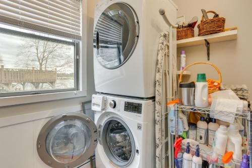 a laundry room with a washing machine and a window at Waterfront Home on White Lake Near Bethel Woods! in White Lake