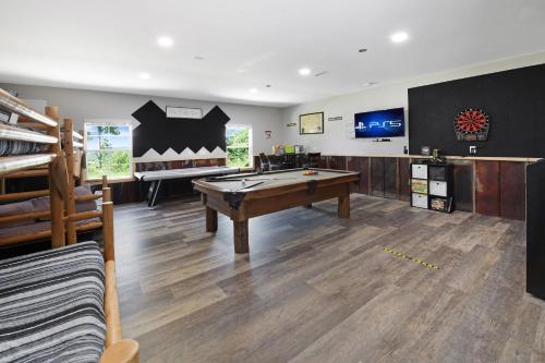 a living room with a pool table and a tv at H2Oasis Incredible Pool Retreat With Mountains Views! in Sevierville