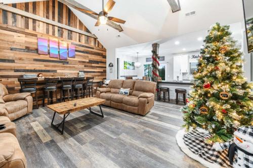 a living room with a christmas tree in the center at H2Oasis Incredible Pool Retreat With Mountains Views! in Sevierville