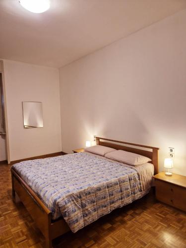 a bedroom with a bed and two night stands at Cà Letizia - ApArt Seregno centralissimo in Seregno