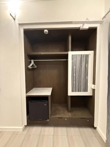 an empty closet with a desk and a window at Paradise by Rashuthere Maldives in Rasdu