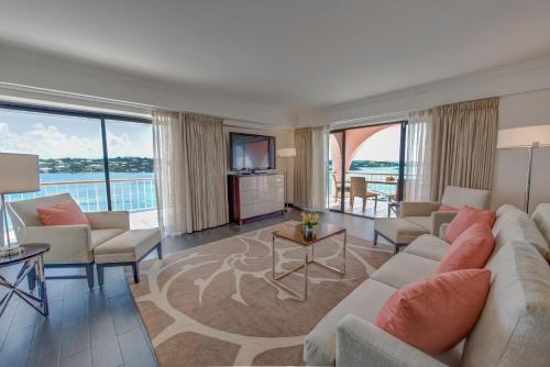 a living room with a couch and a tv at Hamilton Princess & Beach Club A Fairmont Managed Hotel in Hamilton
