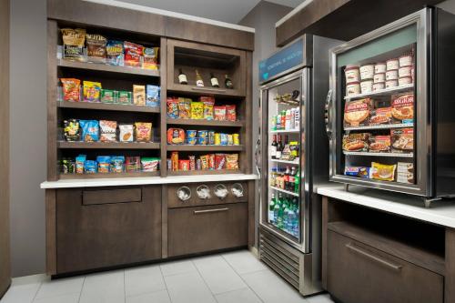 a large refrigerator in a kitchen with food at SpringHill Suites by Marriott Atlanta Perimeter Center in Atlanta