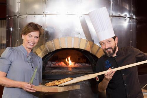 a man and a woman standing in front of a oven at Sheraton Stockholm Hotel in Stockholm