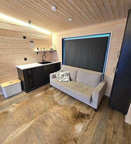 a living room with a dog laying on the floor at Beach cottage with sauna in Kajaani