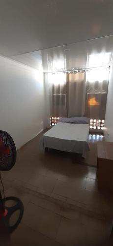 a bedroom with a bed in a room with lights at Hotel Rio Puntarenas in Puntarenas