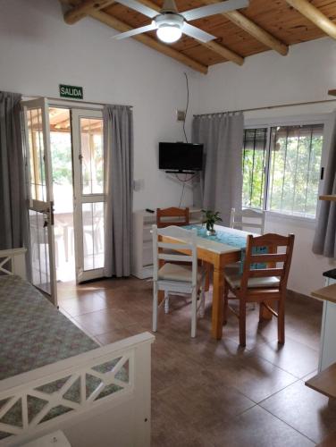 a room with a dining room table and chairs at Cabañas Paraje Noviembre in Nono