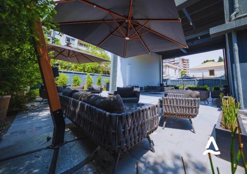 a patio with couches and an umbrella at Almasur Providencia in Santiago