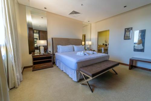 a bedroom with a bed and a table and a mirror at Crowne Plaza Asunción by IHG in Asuncion