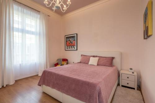una camera da letto con un letto grande e una finestra di Košice - centrum, Apartmán Urban Tower a Košice