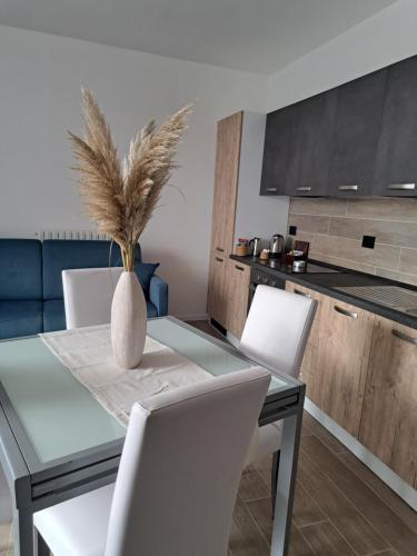 a dining room table with chairs and a vase on it at B&B Le Scintille in San Ginesio