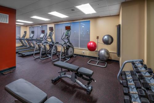 a gym with rows of exercise bikes and weights at TownePlace Suites by Marriott Milwaukee Oak Creek in Oak Creek