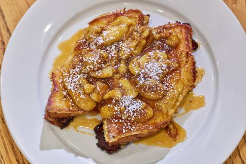 a white plate topped with french toast with powdered sugar at Marriott Vacation Club®, San Diego    in San Diego