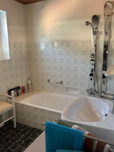 a bathroom with a bath tub and a sink at Ferienhaus Gruber in Aich