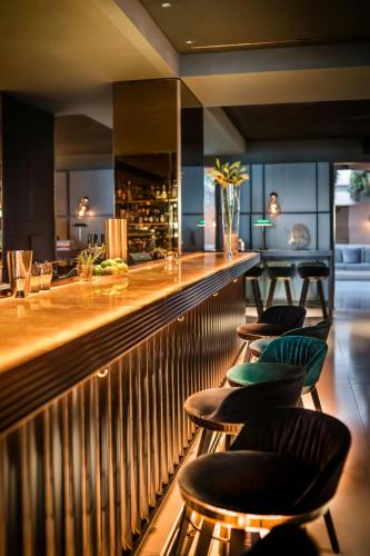 a bar with a bunch of chairs sitting at it at Le Méridien Vienna in Vienna