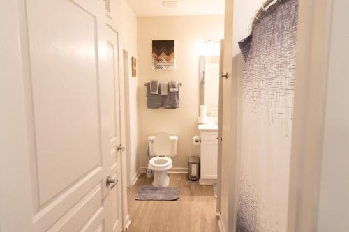 a bathroom with a toilet and a sink at Home Away from Home in Charlotte