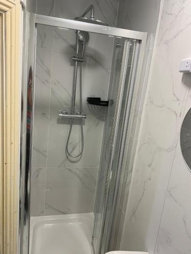 a shower with a glass door in a bathroom at 4 Bed Room Sharing House in Phibblestown