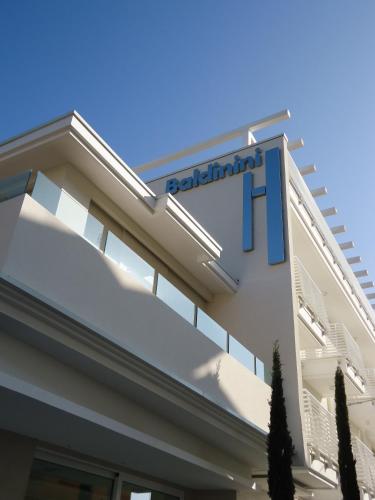 a building with a sign on the side of it at Baldinini Hotel in Rimini