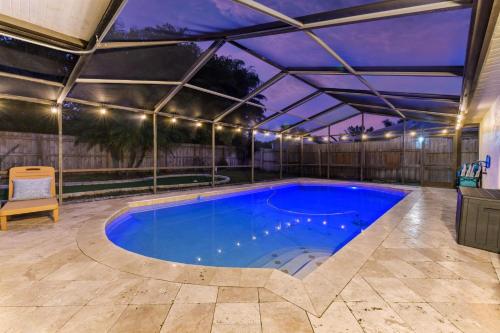 a swimming pool under an awning in a house at Poolside Fun Games Perfect Family Escape in Largo