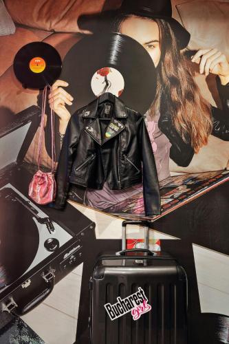 a poster of a woman with a hat and a record at Moxy Bucharest Old Town in Bucharest