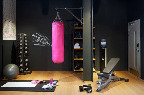 a room with a gym with a pink punching bag at Moxy Milton Keynes in Milton Keynes