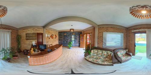 a large living room with a couch and a table at Pousada Askalon in Itaúnas