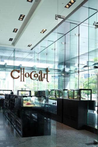 a restaurant with a sign on the glass wall at Le Meridien Taipei in Taipei