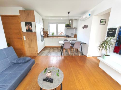 a living room with a couch and a table at Family Nest near Ljubljana with free parking in Dobrova