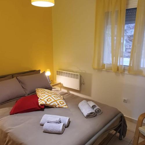 a bedroom with a bed with towels on it at Stelios apartment 2 in Chios
