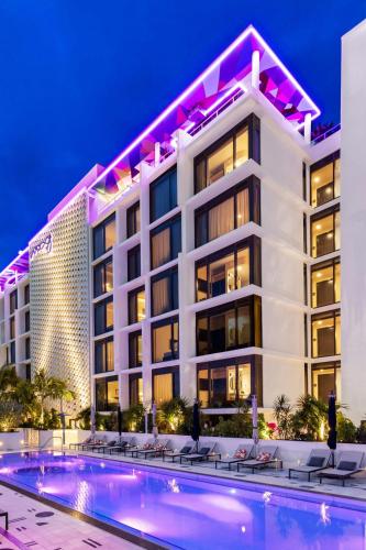 a hotel with a swimming pool at night at Moxy Miami South Beach in Miami Beach