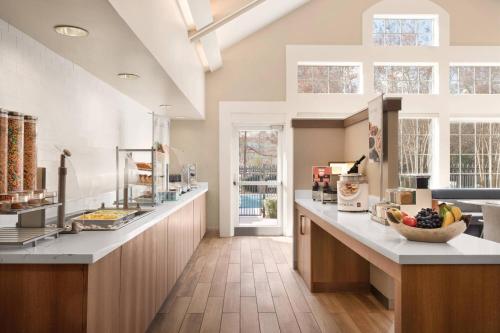 a kitchen with a counter with a bowl of fruit at Residence Inn Atlanta Duluth Gwinnett Place in Duluth