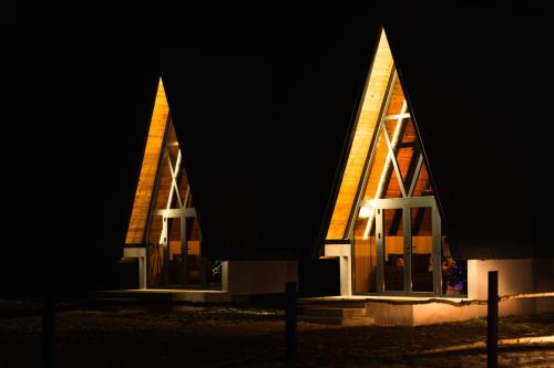 a church with two tall towers at night at Golden Valley Brezna in Pluzine