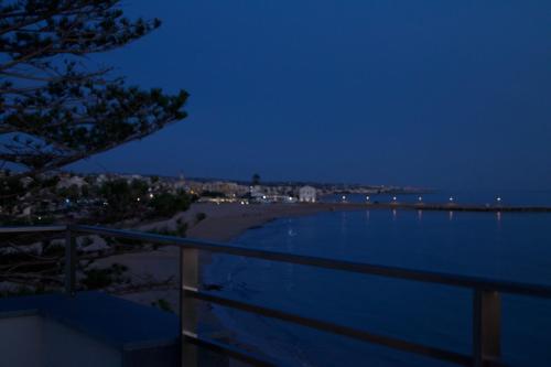a view of the beach at night at Luxury villa Lucy with pool on front of beach of Donnalucata in Donnalucata