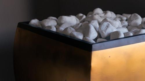 a bowl filled with white rocks on a table at Luxury villa Lucy with pool on front of beach of Donnalucata in Donnalucata