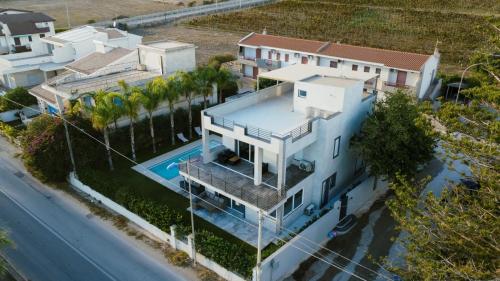 an aerial view of a house with a swimming pool at Luxury villa Lucy with pool on front of beach of Donnalucata in Donnalucata