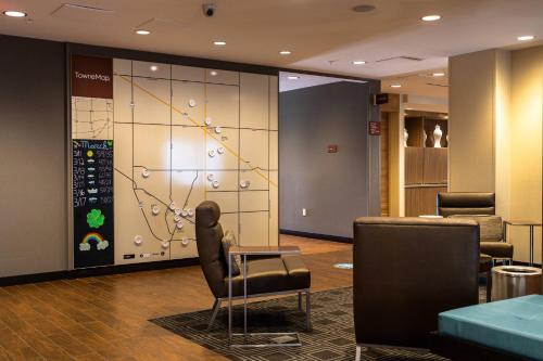 a waiting room with chairs and a wall at Towneplace Suites By Marriott Hays in Hays