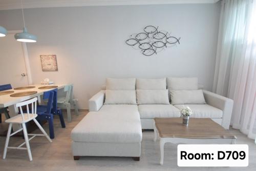 a living room with a white couch and a table at My Resort Hua Hin - by Great Days in Hua Hin