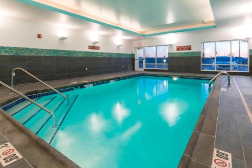 a large swimming pool with blue water at Towneplace Suites By Marriott Hays in Hays
