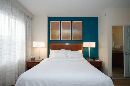 a bedroom with a large white bed with two lamps at Residence Inn Rochester Mayo Clinic Area in Rochester