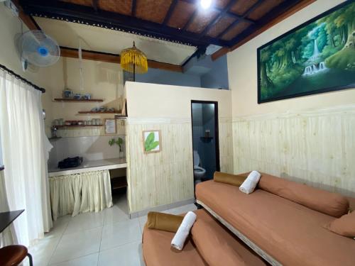 a living room with a couch and a large screen at Coliving Bali SWEET HOME Kost Lengkap di Tabanan Kota in Tabanan
