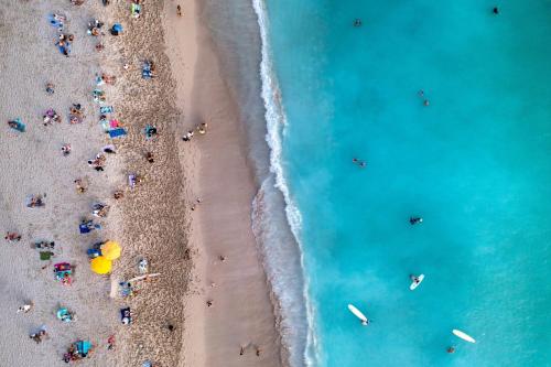 an overhead view of a group of people on the beach at Moana Surfrider, A Westin Resort & Spa, Waikiki Beach in Honolulu