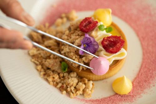 a plate with a dessert with fruit on it at Moana Surfrider, A Westin Resort & Spa, Waikiki Beach in Honolulu