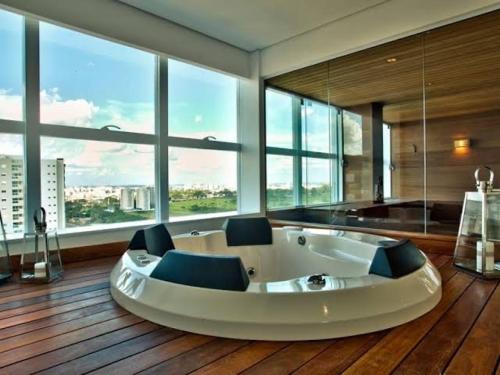 a large room with a large tub in front of windows at Equilíbrio 1316 in Sao Jose do Rio Preto